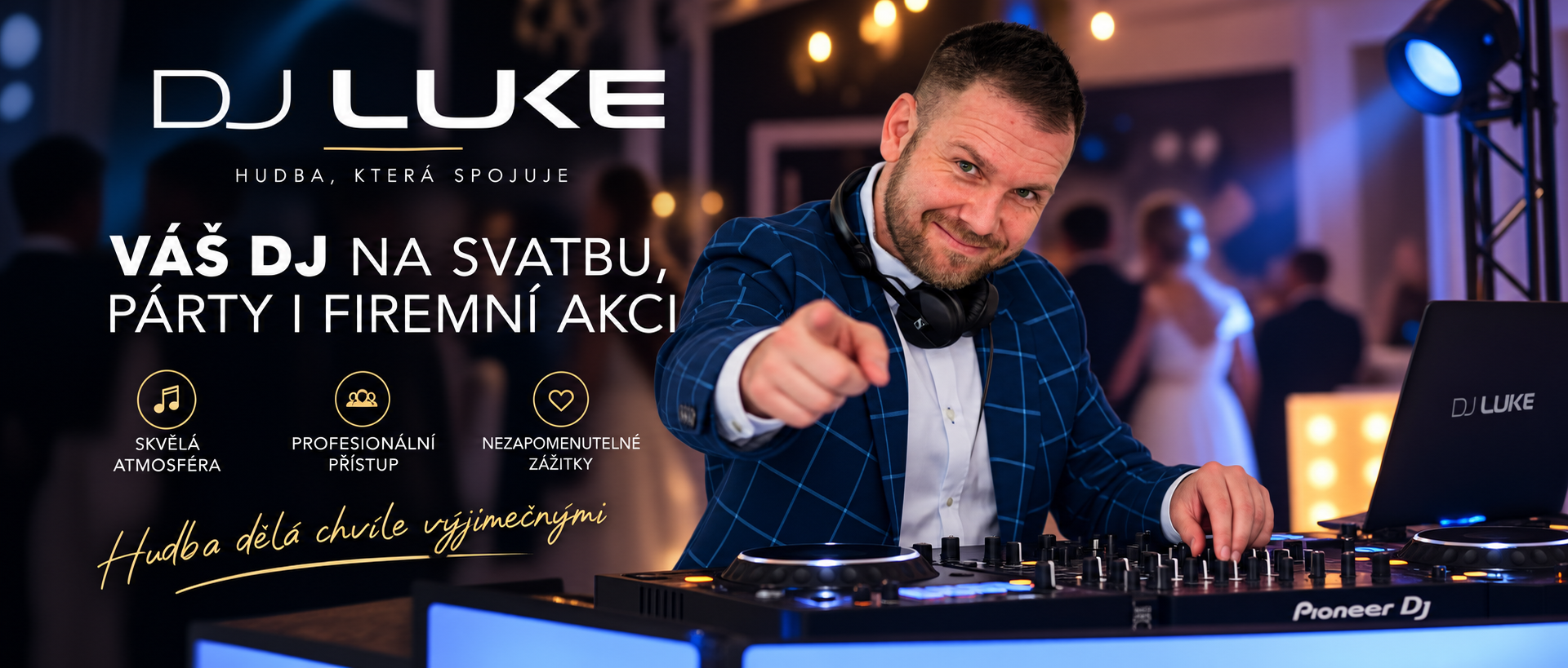DJ Luke v modrém saku u mixážního pultu, ukazuje prstem, v pozadí svatební párty a světla.
